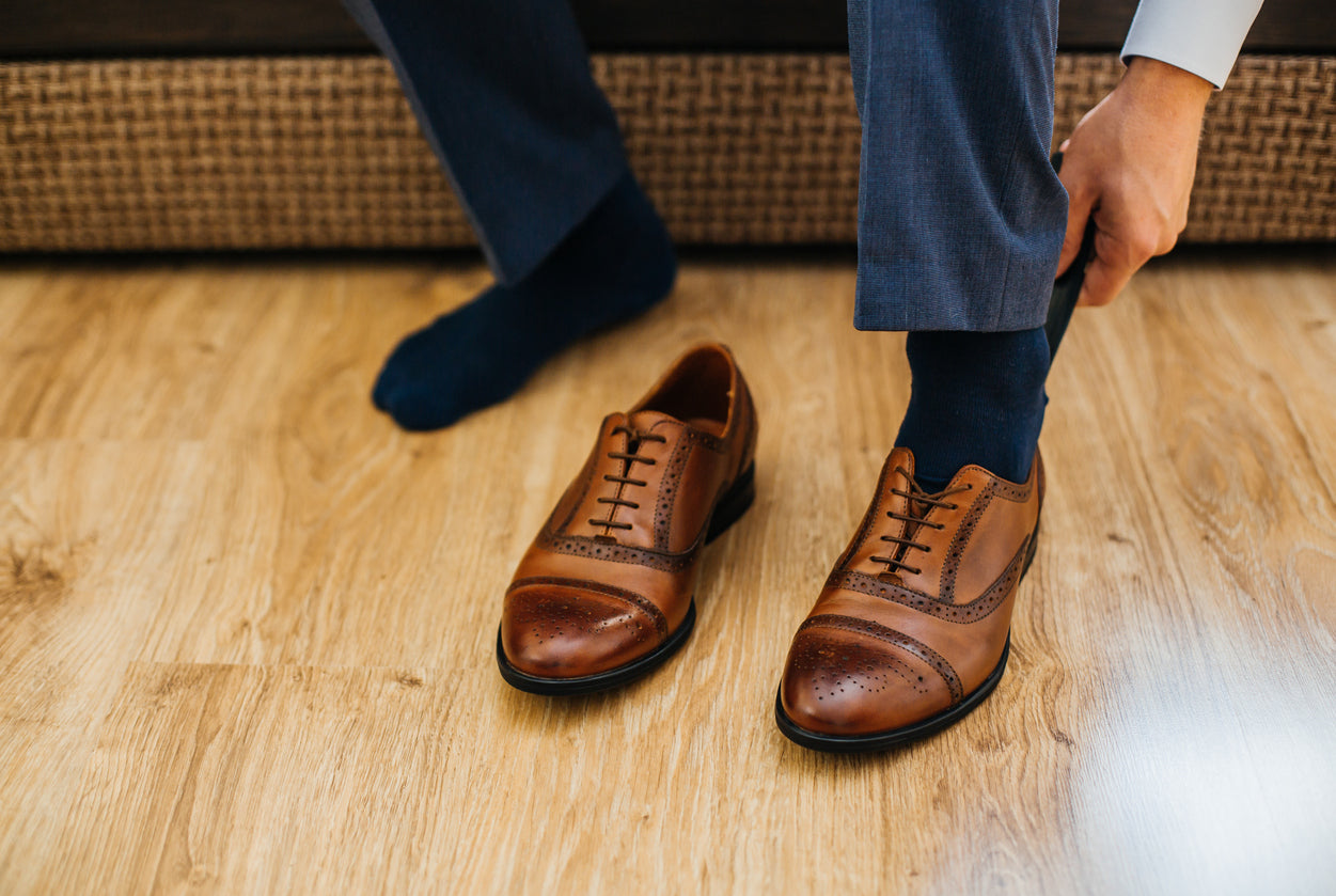 Man Slipping on Brown Loafers